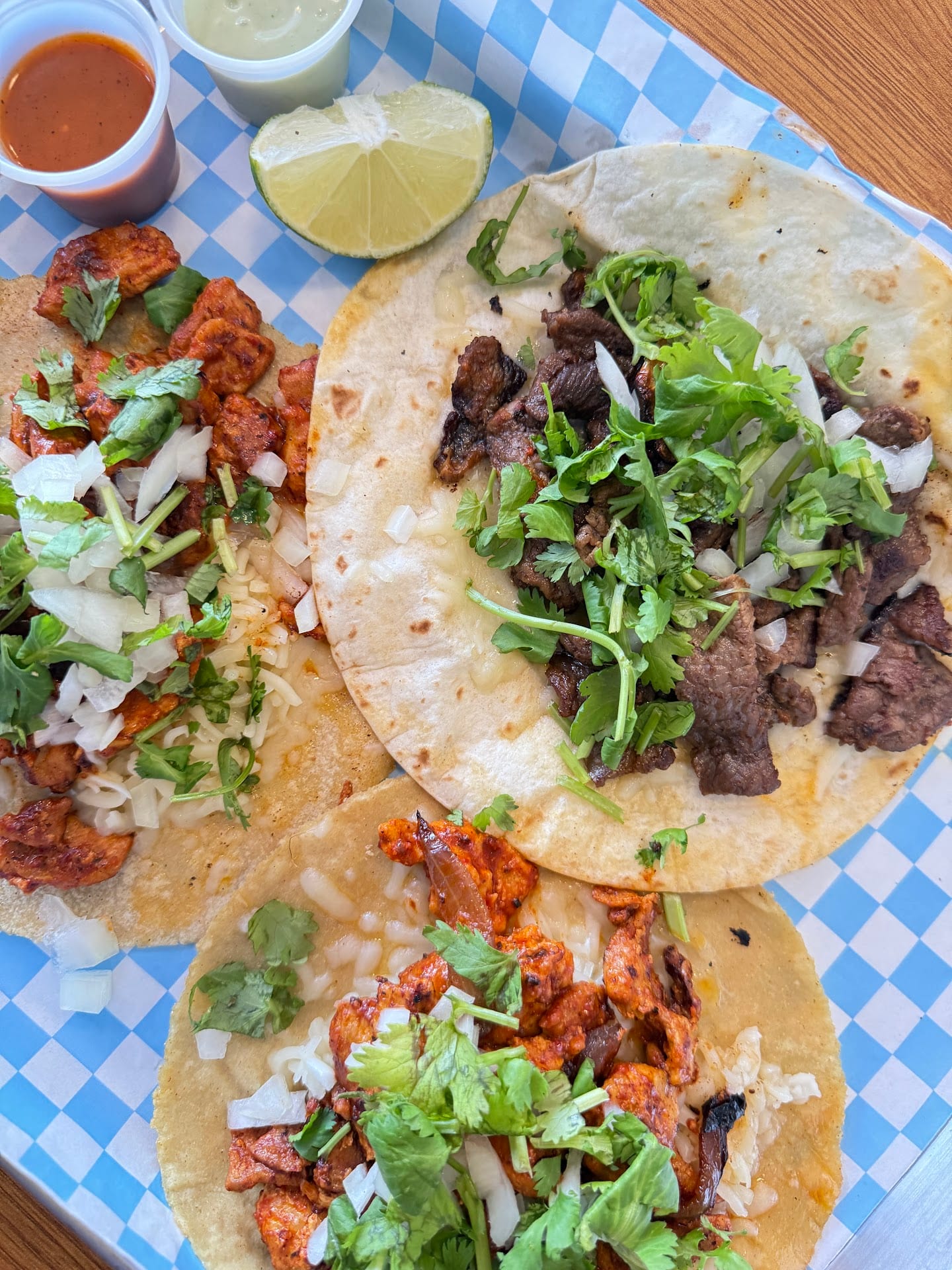 Street tacos with salsa, lime, and fresh cilantro at Sison Tacos