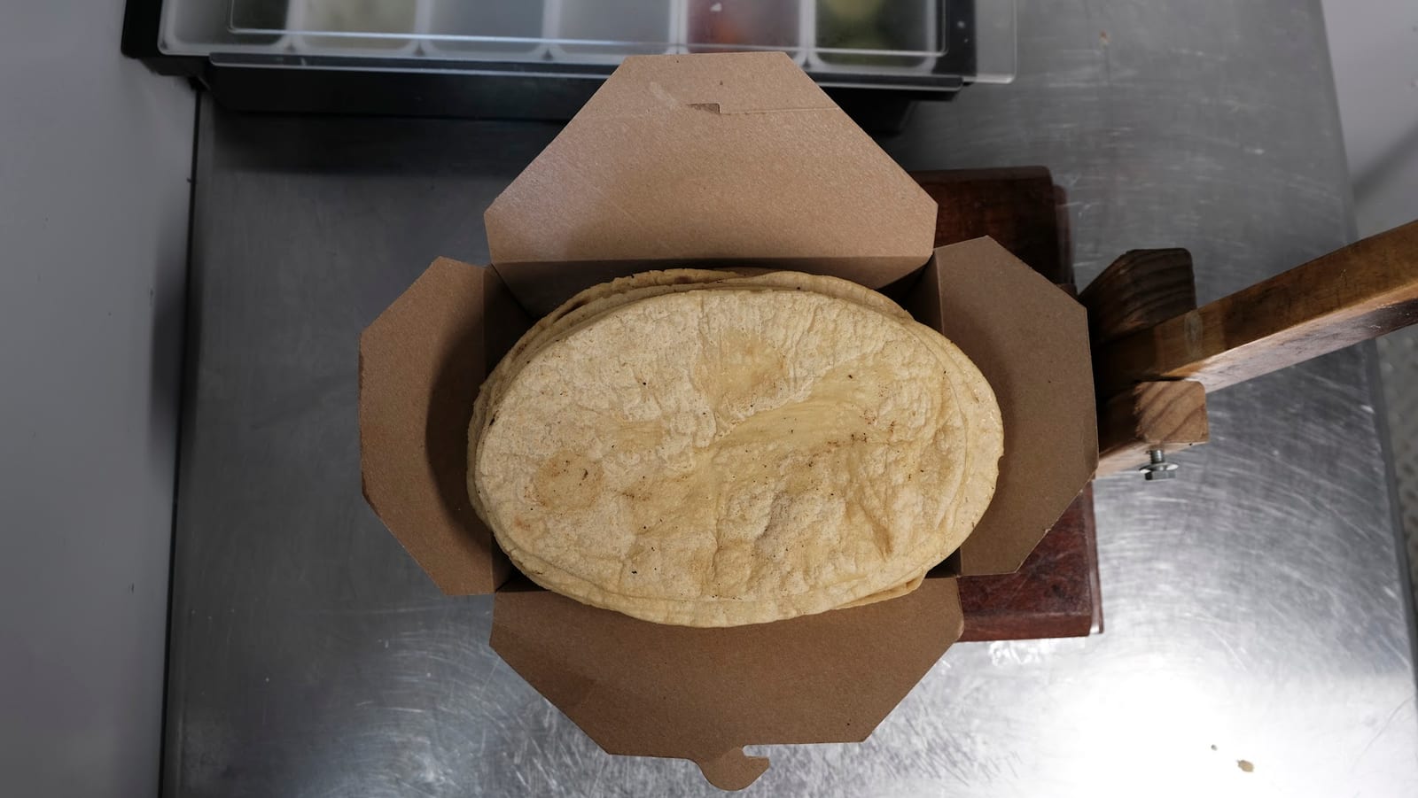 Fresh corn tortillas stacked for service at Sison Tacos